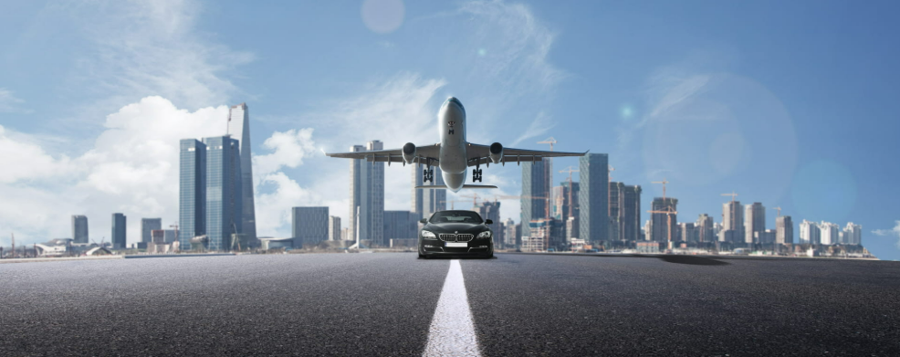 A plane reflected in a car's side mirror symbolizes airport transfer.